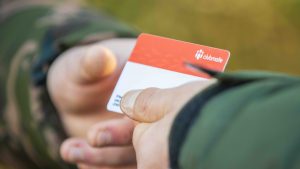 Bailiff checks a photo ID card to stop unauthorised anglers from fishing at their venues without a valid membership.