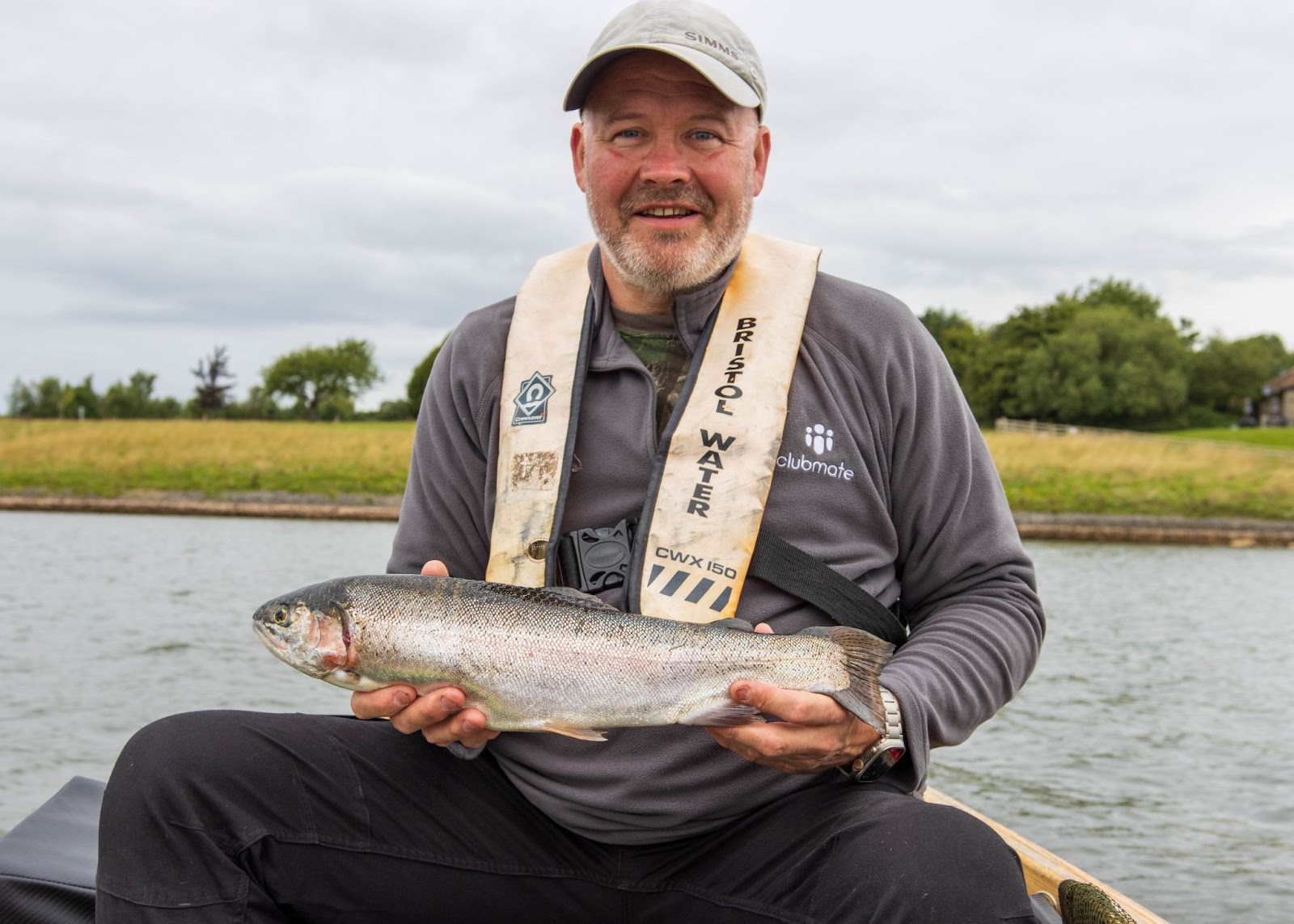 An angler holds a rainbow trout caught at Bristol Water Fisheries.