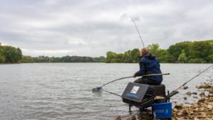Angler reels in a catch during a fishing match.