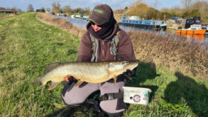 Clubmate’s Client Engagement Specialist Babs holds a Pike caught on the fly during an angling session at her club’s venue.