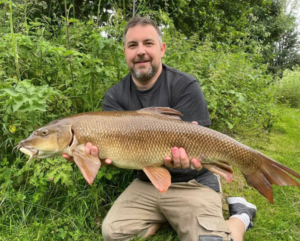 Angler poses with a large catch at Reading & District Angling Club, one of the most popular fishing clubs in the South East of England.