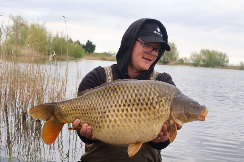 Ulvis displaying a carp he successfully netted at Baston Shallow