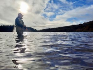 Sceneic image of a flyfisher in knee deep about to cast