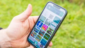 Smartphone in hand with Clubmate member app showing all the available tiles and tools