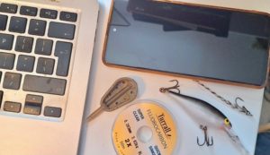 various tackle and technology laid out on a desk